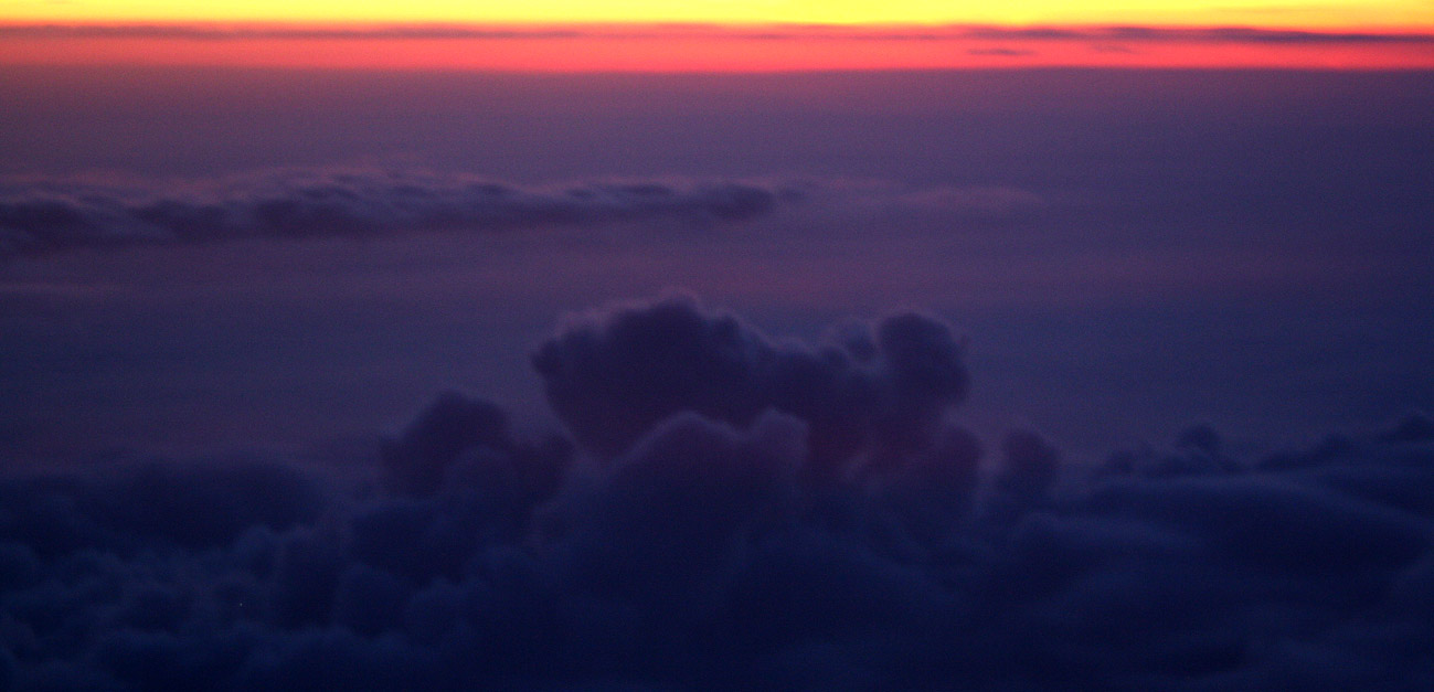 Sunset photograph of clouds from above, taken from an airplane